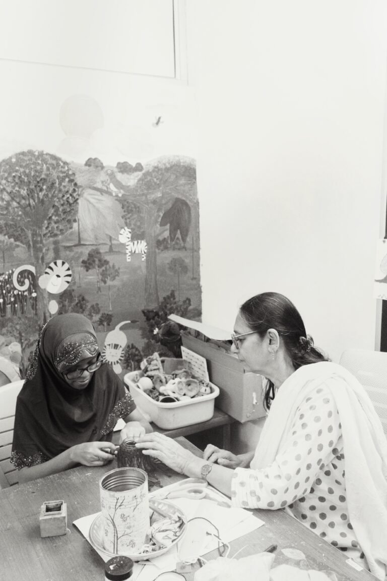 Children learning macrame with a teacher, creating handcrafted jar covers with focus and joy